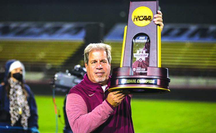Coach Mark Krikorian stands with the NCAA Division I championship trophy after his Florida State University women’s soccer team outlasted Brigham Young for the title in December. (Submitted / Florida State Sports Information Department)