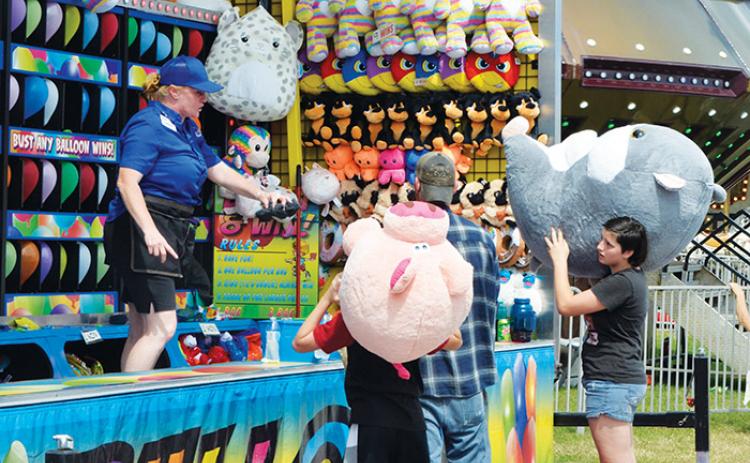 Attendees of the Putnam County Fair win big Saturday after bursting balloons with darts. 