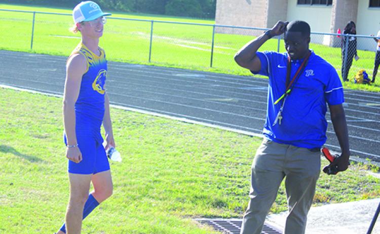 Palatka’s Hayden Newman, shown with head track coach Jarimy Passmore during last week’s Senior Night home meet, won the 100- and 400-meter races at Wednesday’s Stinger Invitational at St. Augustine High School. (MARK BLUMENTHAL / Palatka Daily News)