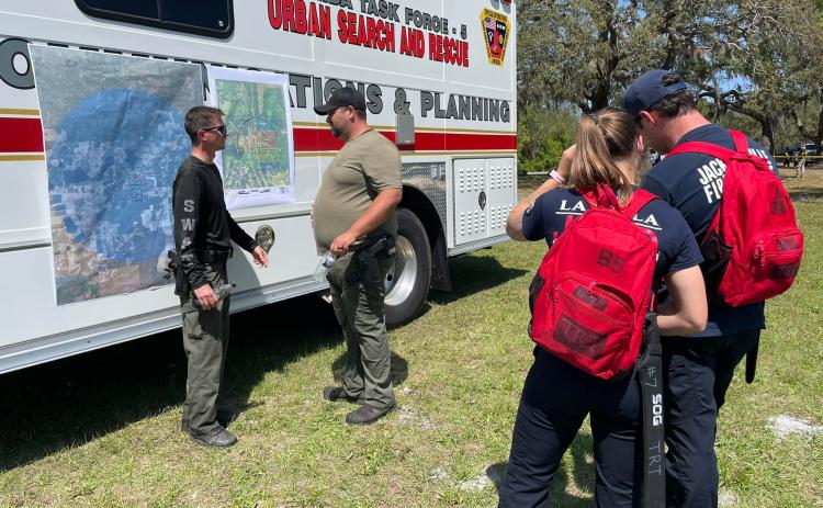 First responders coordinate search efforts near Jose Lara's home Monday.