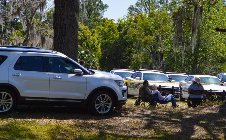 Photo by Sarah Cavacini/Palatka Daily News. Volunteers, including Palm Coast woman Julie Jarosz (right), sit near first responders' vehicles Monday, waiting to help if they are called. First responders, however, did not call on civilian responders during the 24-hour search for Jose Lara.