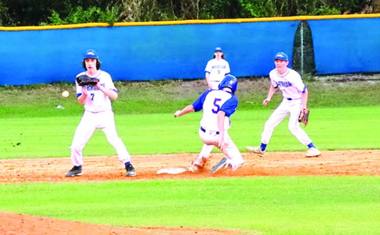 Palatka courtesy runner Corey Baggs steals second base as Peniel Baptist Academy’s Nick Fisher takes the throw in the fourth inning Friday. (RITA FULLERTON / Special to the Daily News)