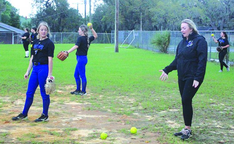 Palatka head softball coach Katelynn Smith (right) makes a point to one of her pitchers, Molly Albritton, during Thursday’s practice. (MARK BLUMENTHAL / Palatka Daily News)