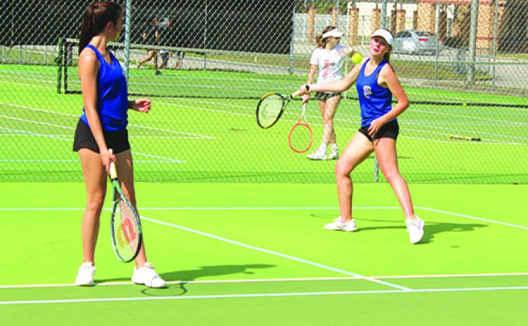 Palatka’s Elle Herrington (left) watches second doubles teammate Paige Griner return a shot during practice before a recent match. The pair will play together and as singles competitors in next week’s district tournament at Palatka. (MARK BLUMENTHAL / Palatka Daily News)