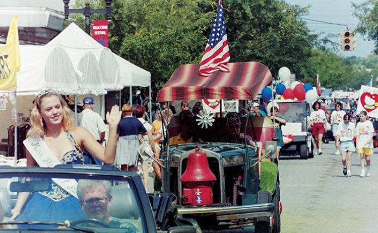 A pageant queen waves to the crowd while participating in the Memorial Day parade during the Blue Crab Festival in 1996.