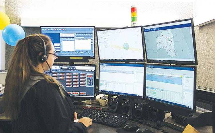 Cassie Blehm-Cummings monitors Putnam County’s emergencies on her six computer screens Wednesday.