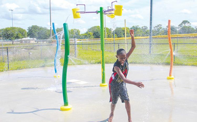 Ayden Coley hangs out at the Project P.L.A.Y. splash pad Monday as it reopened after being fixed in time for spring.