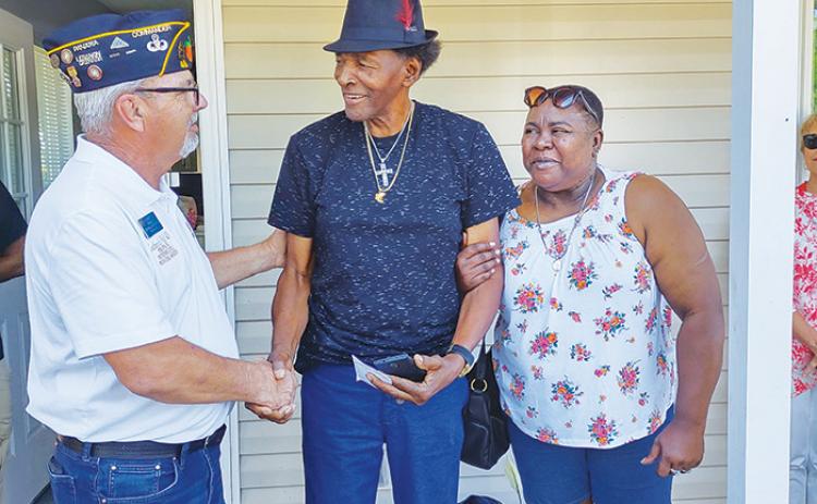 Freddie and Pauline Lewis receive congratulations from American Legion Bert Hodge Post 45 Commander Ken Moore, left, after their future home at Veterans Village in Palatka is dedicated in July 2021.