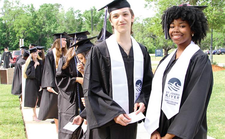 Brady Echols and Amari Caruthers stand in line Friday ahead of St. Johns River State College’s spring commencement ceremony.