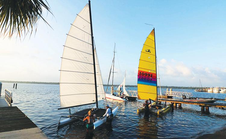 Mug Race participants ready their vessels to launch just north of Memorial Bridge in Palatka for the annual event, where boats sail 38 nautical miles to Orange Park.