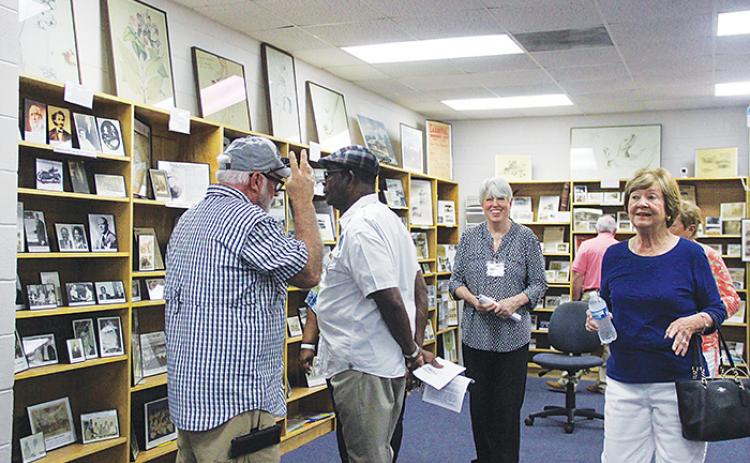 Guests admire the Margary Neal Jones Nelson Archives on Saturday at George C. Miller Middle School. 