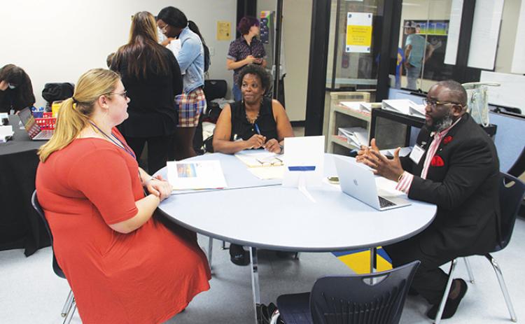 Palatka City Commissioner Justin Campbell, right, speaks to Palatka Junior-Senior High School student Mykaela Anderson, left, in a mock interview Friday.