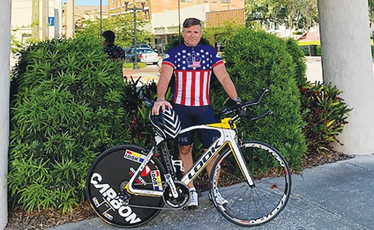 J.J. Gullett stands outside Gullett Title in Palatka as he prepares to go for a bicycle ride.