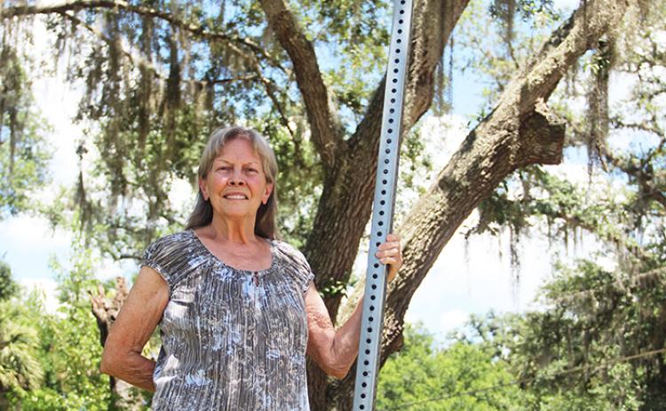 Photo by Sarah Cavacini/Palatka Daily News. Jan Tedder stands on the corner of her road earlier this month. 