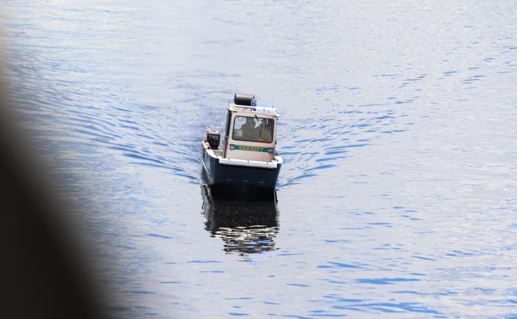 Photo by Sarah Cavacini/Palatka Daily News. A Putnam County Sheriff's Office boat searches Tuesday for a man who reportedly jumped from Memorial Bridge that day. 