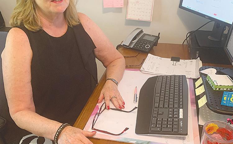 Susan Detar, the founder and owner of The Pink Door in Palatka, sits at her desk to discuss the need for her business, which provides bras to women who have had breast surgery.
