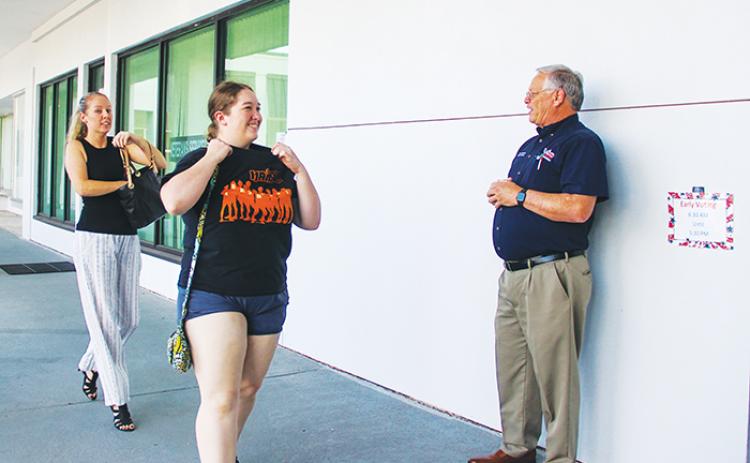 Supervisor of Elections Charles Overturf III talks to Putnam County voters Myranda Goddard and Jennifer Jones, who brought their sample ballots with them Monday to vote early at the Elections Office in Palatka. Early voting will continue 8:30 a.m. – 5:30 p.m. today through Saturday.