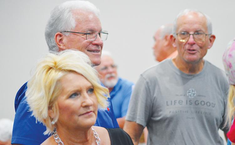 Phil Leary, left - one of Putnam County's newly elected school board members - watches election results Tuesday alongside Crescent City Mayor Michele Myers, front, and Bob Lee, right.