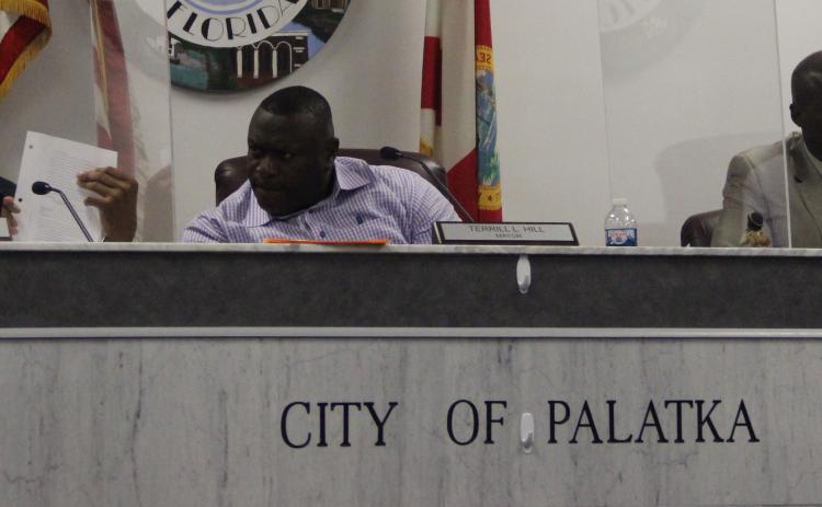 Commissioner Will Jones, left, and Mayor Terrill Hill, center, examine a document at Thursday's city commission meeting before voting to approve an 850-square-foot minimum on new residences built within Palatka limits. Commissioner Rufus Borom, right, voted against the ordinance, arguing that a 1,200-square-foot minimum would be better for property values.