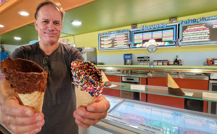 Photo by Casmira Harrison/Palatka Daily News. Renni Thompson shows off a few of the tasty chocolate-dipped cones available to hold several of the 46 different ice cream flavors at his new Pomona Park ice cream and sandwich shop, 12 Below Zero.  sh
