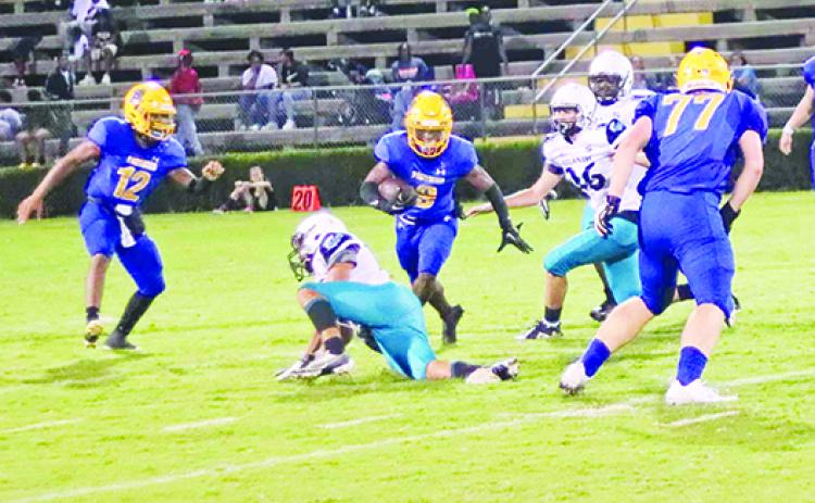 Palatka running back Ishmael Foster (8) looks to weave between Port Orange Atlantic defenders as well as Palatka quarterback Jamarrie McKinnon (12) and lineman Javen Palmer during Friday night’s game. (RITA FULLERTON / Special to the Daily News)