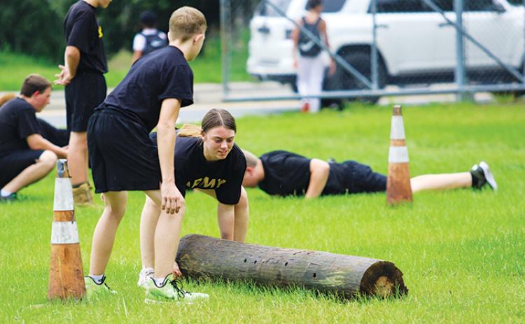 Interlachen Junior-Senior High JROTC cadet Whitney Champion works through a set of log flips to train for the team’s competition season.