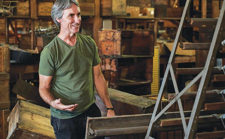 Mike Wolfe, a co-host of “American Pickers,” stands among antiques to see if he can find something valuable among what one of the people featured on the show has to offer from their private collection.
