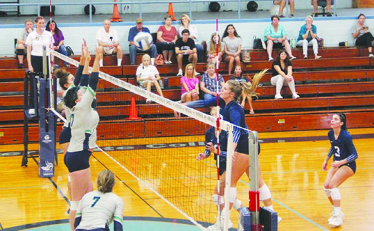 St. Johns River State College’s Hope Herrington (right) delivers a kill attempt past Pensacola’s Reagan Dotson (17) during Saturday’s three-set victory. (COREY DAVIS / Palatka Daily News)