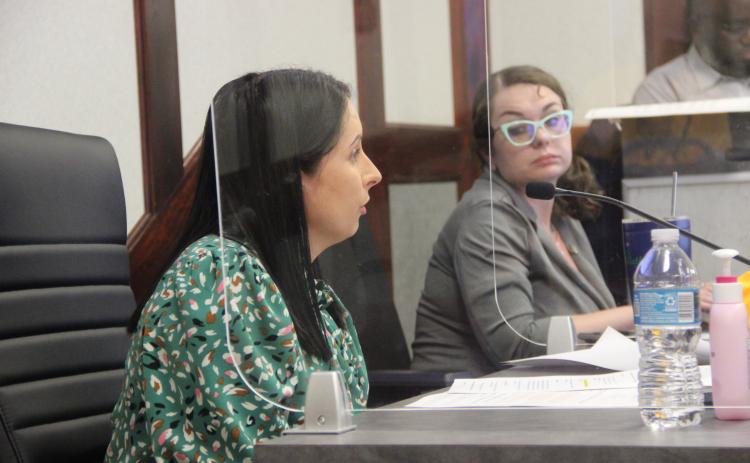 Finance Director Lauren Shank, left, speaks to commissioners Thursday about next steps in the budget process as Interim City Clerk Sunni Krantz, right, listens.