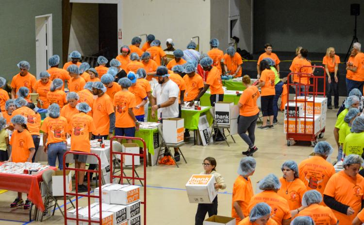Teams of volunteers pack 30,000 meals for Feed the Need of Putnam County on Thursday at Grace Fellowship Church in Palatka.  (SARAH CAVACINI/Palatka Daily News)