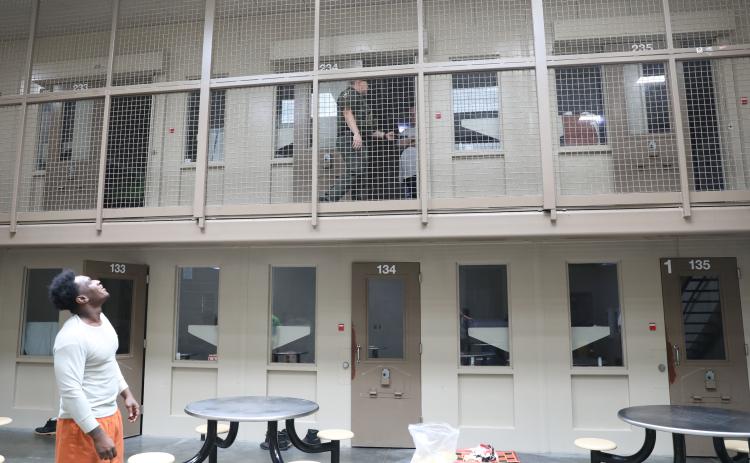 An inmate watches as Corrections Deputy Michael Walker conducts an inmate welfare check in one of the pods at the Putnam County Jail. (Photo courtesy of the Putnam County Sheriff's Office.)
