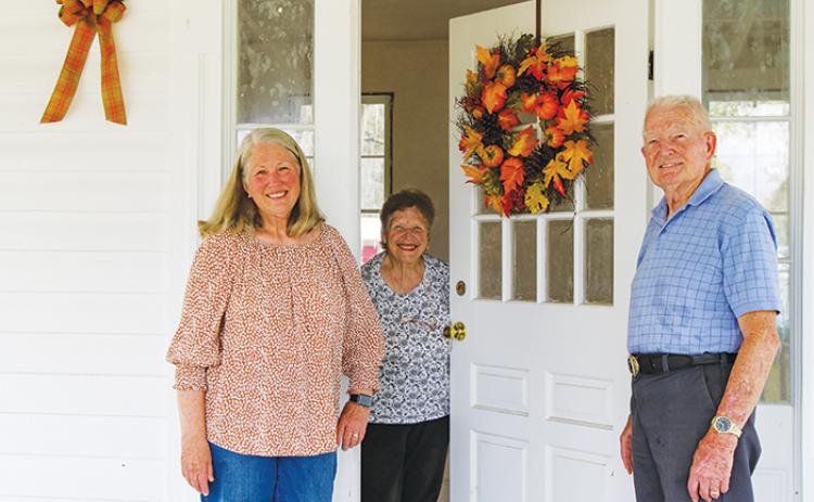 Florahome residents, from left, Meri-lin Piantanida, Betty Carnes and Ronnie Carnes smile as they stand at the town’s historic clubhouse Wednesday. 