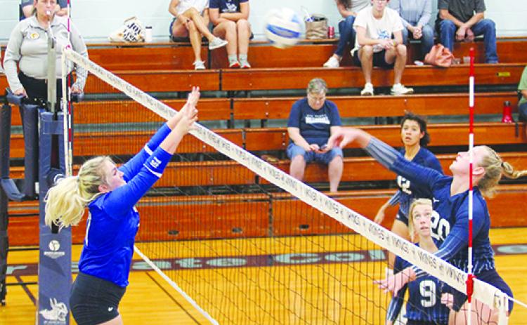 St. Johns River State College’s Cassidy Casey delivers a kill attempt against Florida State College-Jacksonville’s Marissa Hauser in the second of Wednesday’s match at Tuten Gymnasium. (MARK BLUMENTHAL / Palatka Daily News)