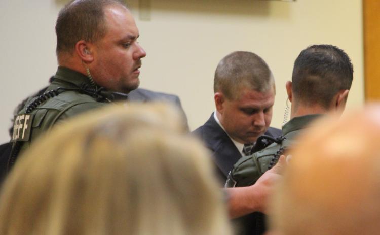 Deputies escort Mark Wilson Jr. from the Putnam County Courthouse Annex following a jury's recommendation of death.