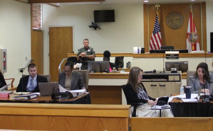 The defense and prosecution in the trial of Mark Wilson Jr., third from left, prepare for jury selection Monday morning.