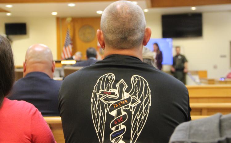 A loved one wears a shirt honoring Tayten and Robert Baker's memory during Mark Wilson Jr.'s murder trial Tuesday.