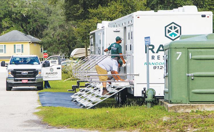 Mobile showers and bathrooms are set up Friday at the edge of Sportsman Harbor in Welaka. 