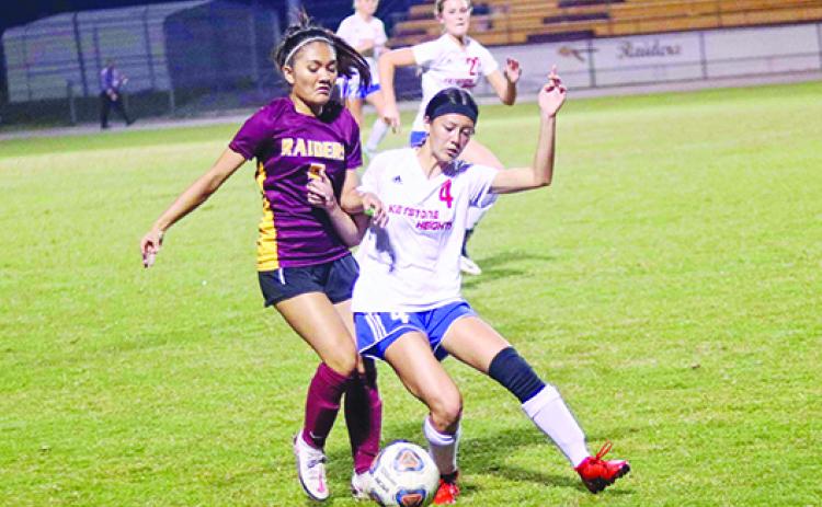 Crescent City’s Maylin Vallaincourt battles for the ball with Keystone Heights’ Halea Lam in the first half of Tuesday night’s game. (RITA FULLERTON / Special to the Daily News)