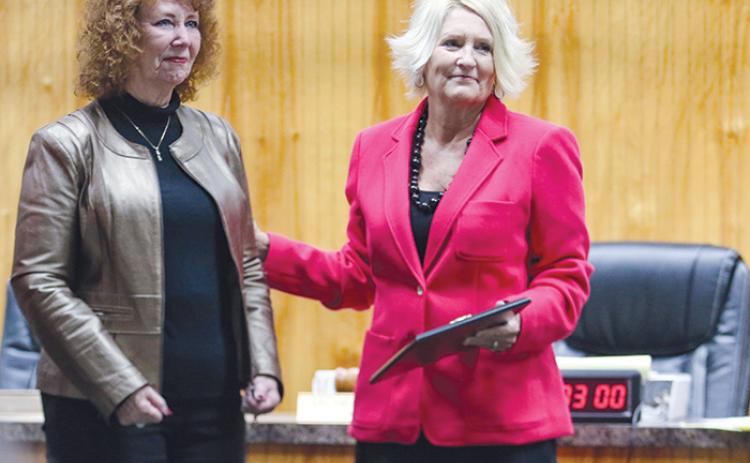 Former Crescent City Commissioner Judy West, left, stands next to Mayor Michele Myers as she is honored Monday night for serving as a commissioner for nearly 30 years.