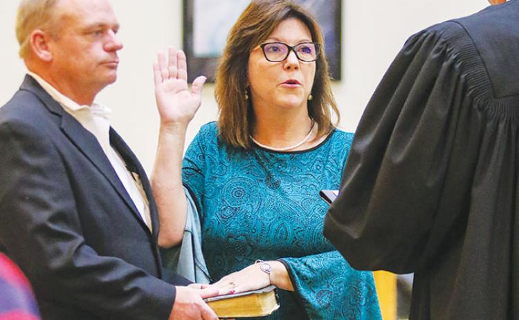 County Commissioner Leota Wilkinson stands with her husband, Eugene, as she takes her oath of office Tuesday morning before serving in her first meeting as the District 2 commissioner.
