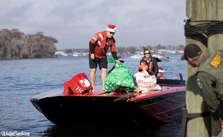 Boaters hand off sacks full of toys to a Putnam County Sheriff's Office deputy during a previous Toys Tour. 