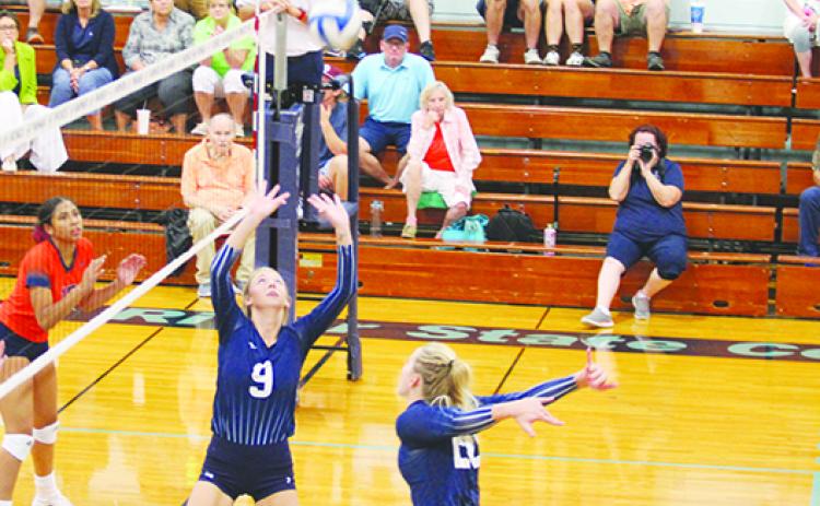 St. Johns River State College's Julianne Lindsey (left) sets up Cassidy Casey for a kill attempt in a match last August. (MARK BLUMENTHAL / Palatka Daily News)