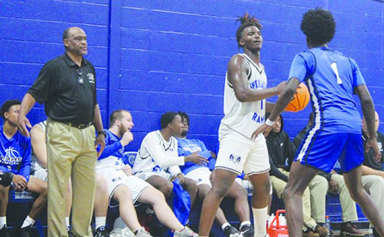 Interlachen coach C.S. Belton (left) watches Rams senior Justin Herring (1) try to find an open teammate while Clay’s J’den Golding covers him Monday night. (MARK BLUMENTHAL / Palatka Daily News)