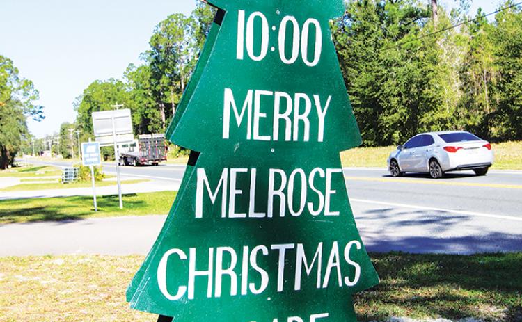 A sign advertising the Merry Melrose Christmas Parade sits outside the Melrose post office Wednesday.