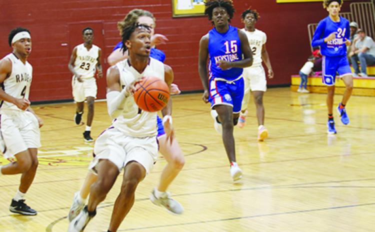 Crescent City’s Lentavious Keenon drives to the basket while being pursued by Keystone Heights’ Bryce Hollingsworth (behind) and Cartez Daniels (15) Thursday night. (COREY DAVIS / Palatka Daily News)
