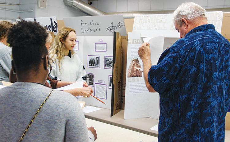 Judges interview Peniel Academy student Joellie Tucker on Friday about her history project, “Frontiers in Fashion: The Knee-Length Skirt.”