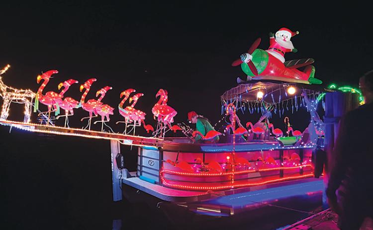 Santa Claus’ Christmas flamingos are ready to pull a boat Saturday during Welaka’s boat parade on the St. Johns River.
