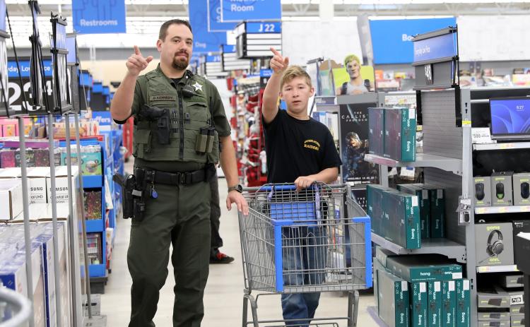 A teenager and a Putnam County sheriff's deputy go shopping in the Palatka Walmart on Sunday as "shop with a deputy" returns. Photo courtesy of the Putnam County Sheriff's Office.