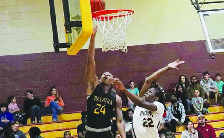 Palatka’s Mario Bryant (245) puts up a shot against Crescent City’s Freddie Major during Wednesday night’s game in the Pooh Bear Williams Classic, won by the Panthers, 68-38. (RITA FULLERTON / Special to the Daily News)