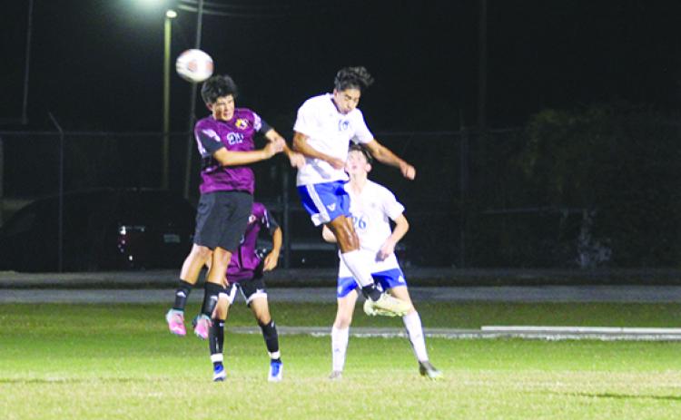Crescent City’s Jaasial Benitez (left) goes up for a headball against Palm Coast Matanzas’ Giancarlo Gonzalez during Tuesday night’s match. (MARK BLUMENTHAL / Palatka Daily News)